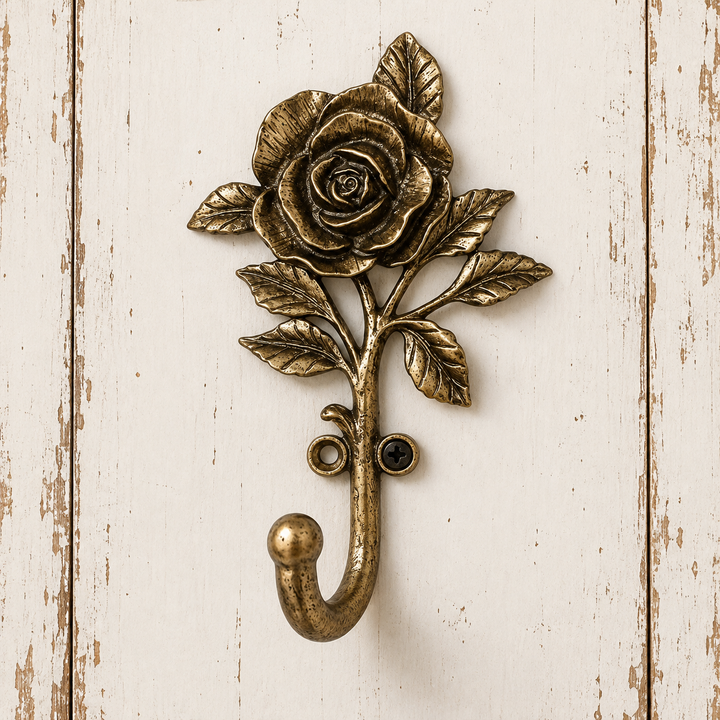 Open rose wall hook mounted on a pale wood surface
