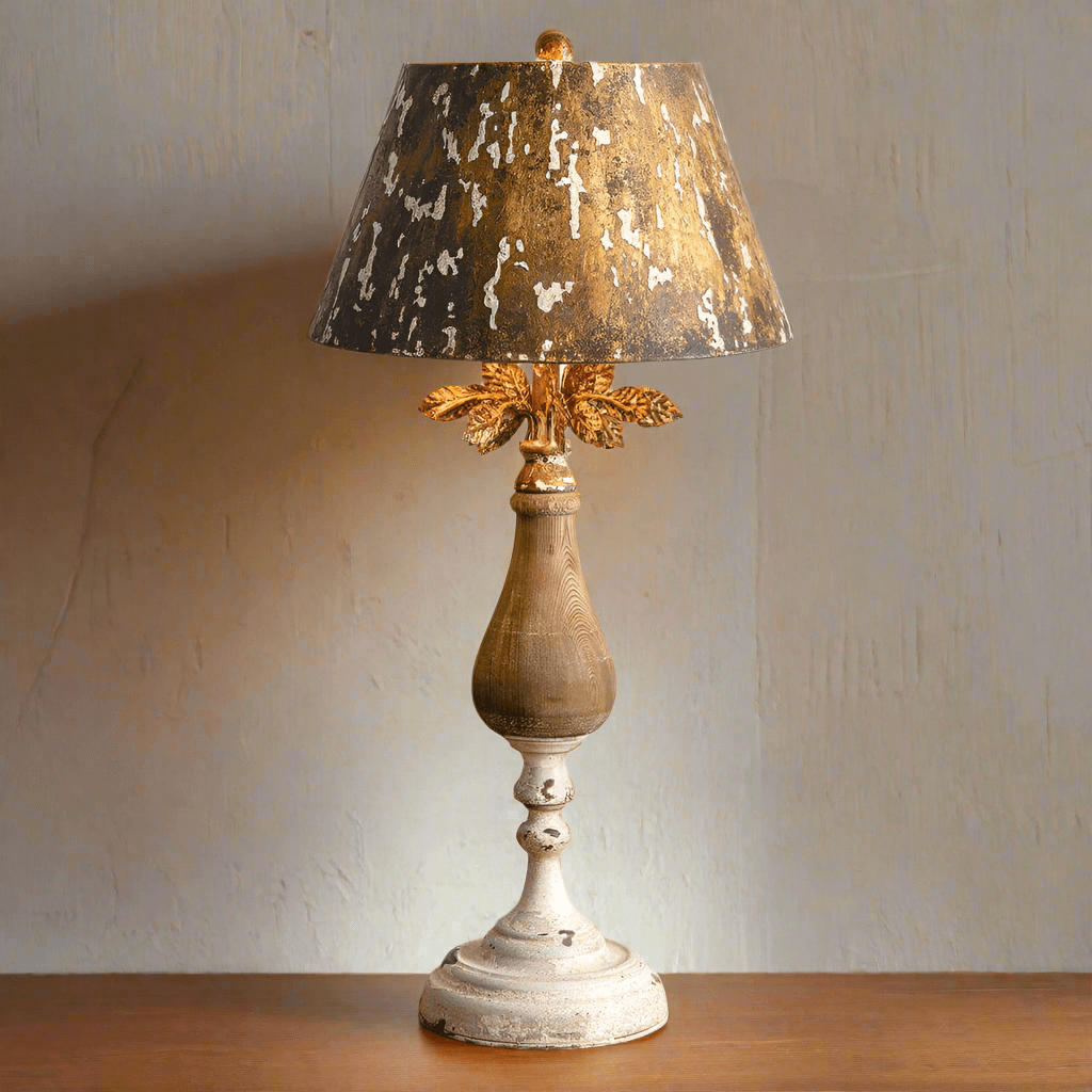 Antique gold table lamp with distressed wood base and decorative shade, adding vintage elegance to any space.