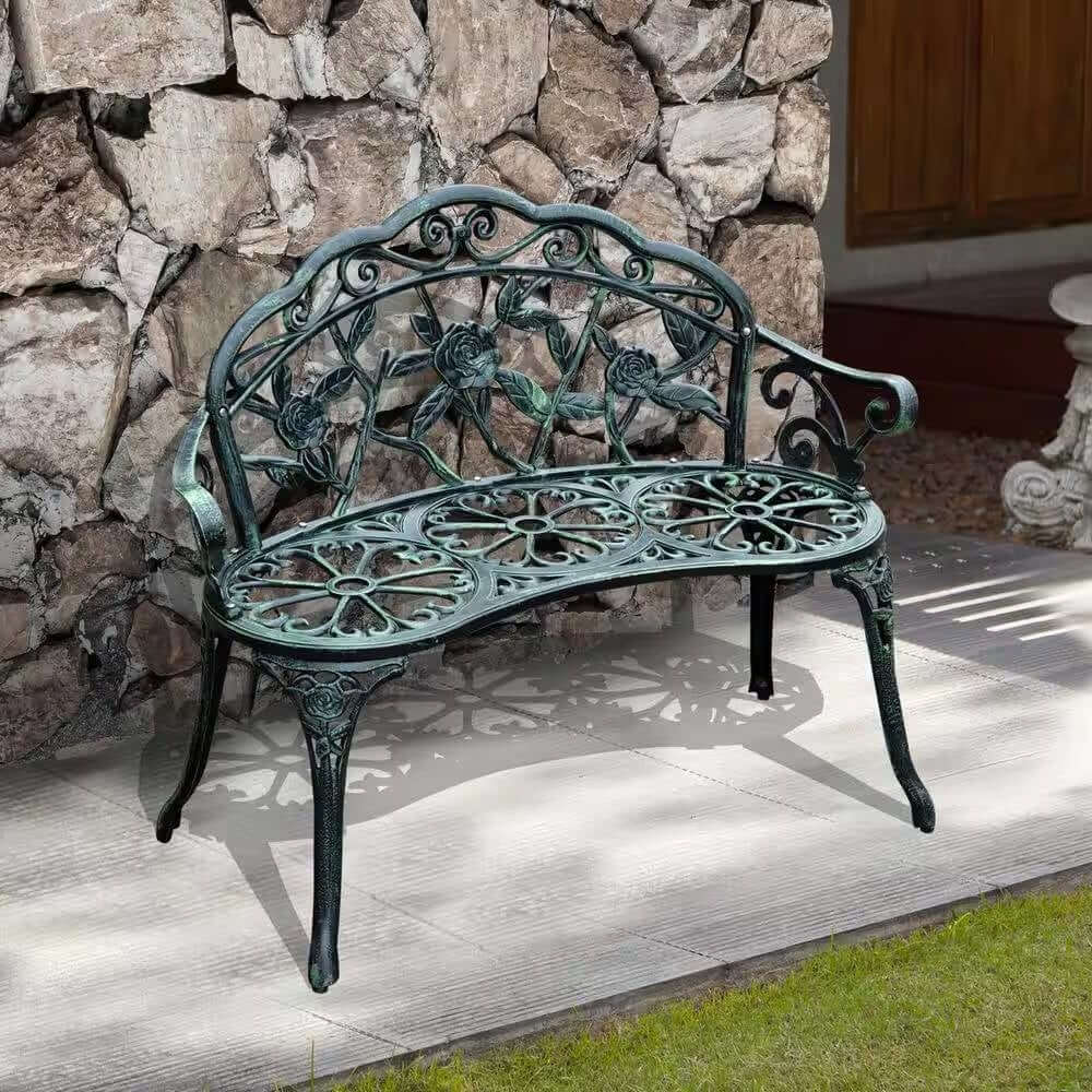 Antique Green Metal Garden Bench with Rose Backrest in a garden setting, featuring vintage floral design and Victorian style detailing.