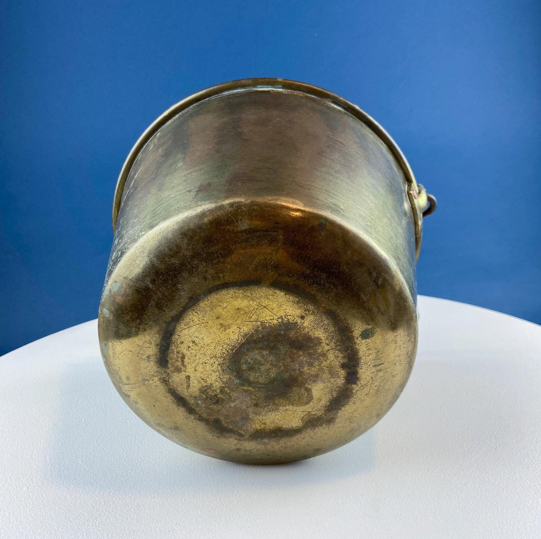 Antique Hand-Hammered Brass Bucket with Wrought Iron Handle: Rustic Farmhouse Decor - view from bottom, showcasing craftsmanship and rustic charm.