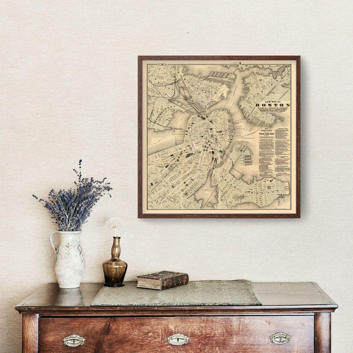Antique Map of Boston, Massachusetts from 1884 displayed above a vintage sideboard with decor items.