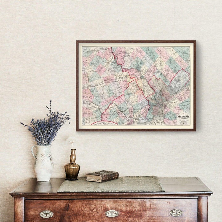Antique Map of Philadelphia, Pennsylvania from 1882 displayed on a wall above a vintage wooden table with decor items
