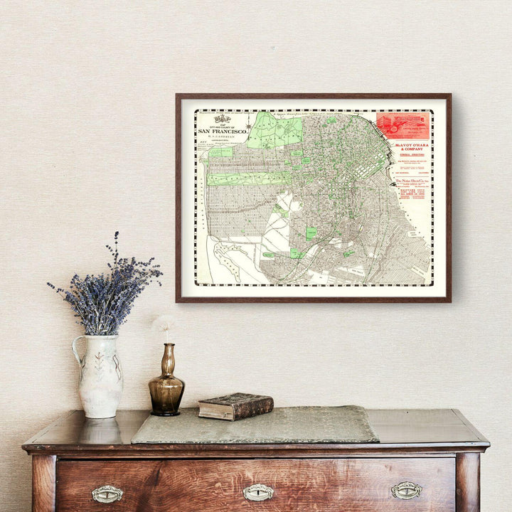 Framed Antique Map of San Francisco, California from 1906 on wall above vintage dresser.