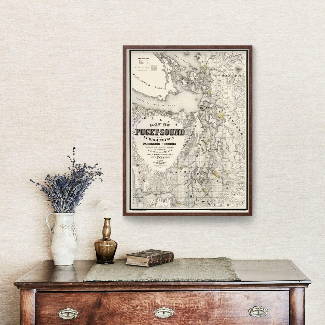 Antique Map of Seattle, Washington from 1877 displayed above wooden sideboard with vase and candle.