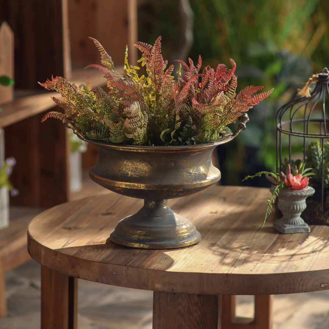 Antique Patina Pedestal Bowl Planter filled with ferns on a round wood table