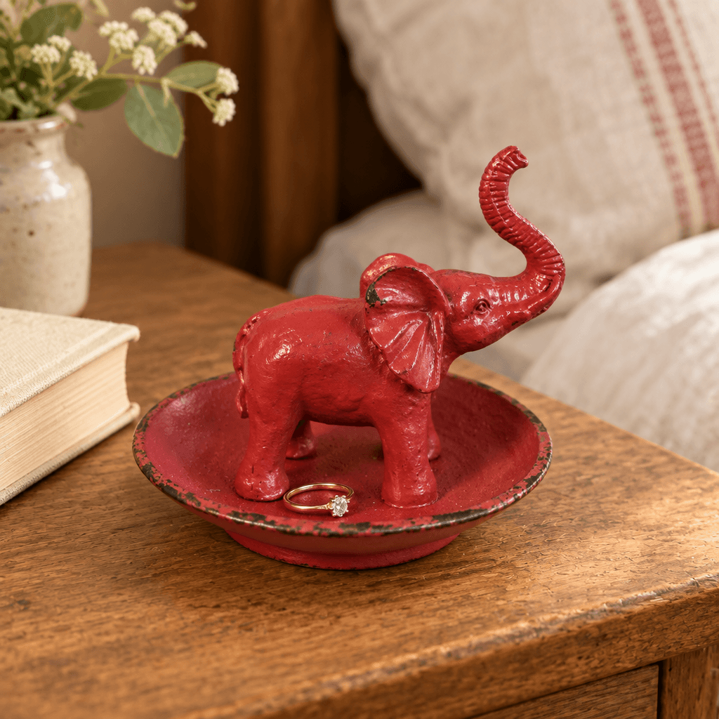 Antique Red Pewter Elephant Ring Dish styled on an oak bedside table
