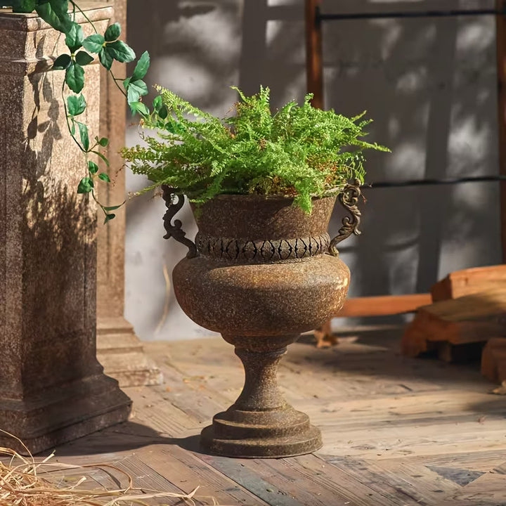 Antique Rust Iron Urn Planter with Scroll Handles planted with a fern