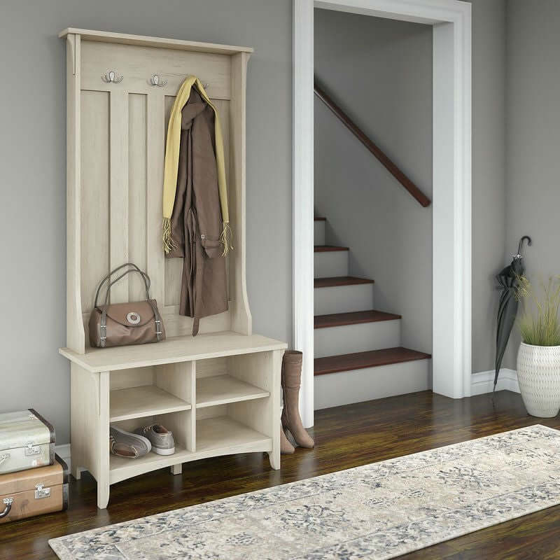 Antique White Entryway Hall Tree with Storage Bench in a rustic farmhouse setting with accessory hooks and shoe storage.