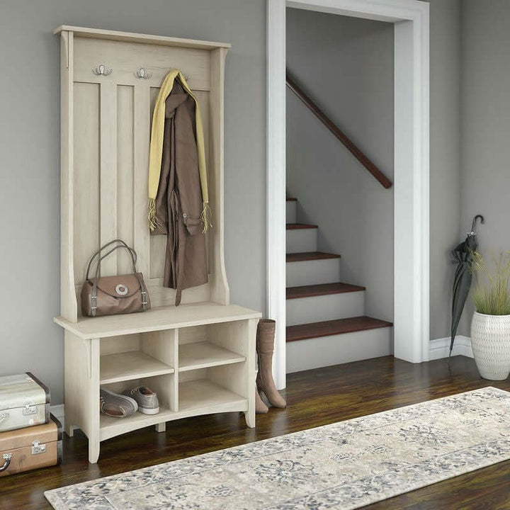 Antique White Entryway Hall Tree with Storage Bench in a rustic farmhouse setting with accessory hooks and shoe storage.