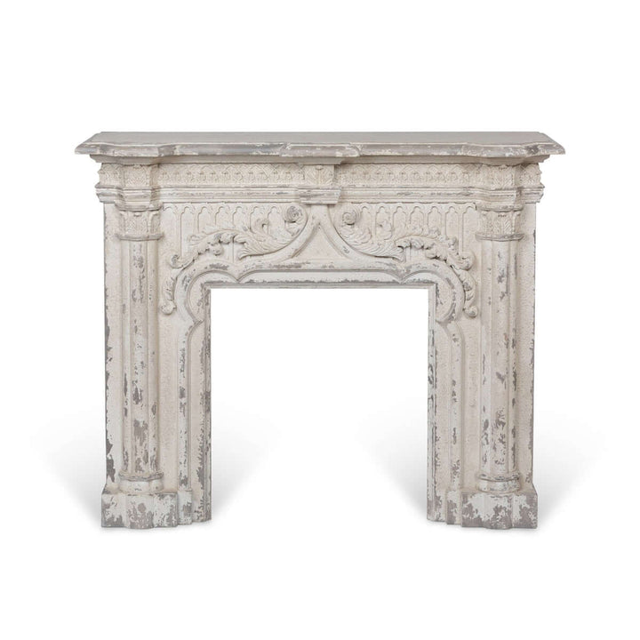 Antique white fireplace mantel with distressed vintage finish showcasing elegant silhouette and timeless charm.