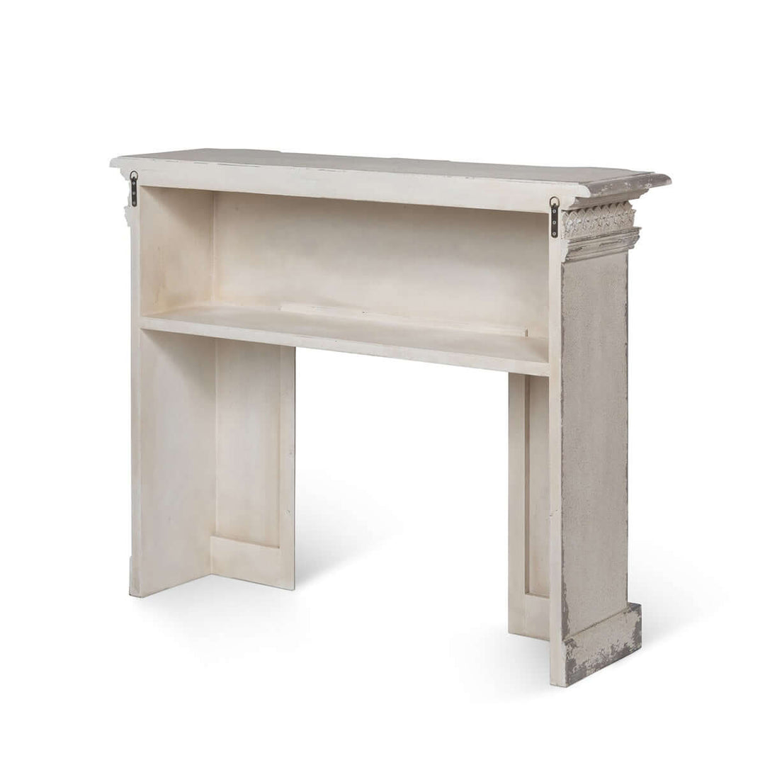 Antique white fireplace mantel with distressed vintage finish, showcasing elegant, timeless charm and classic artistry in design.