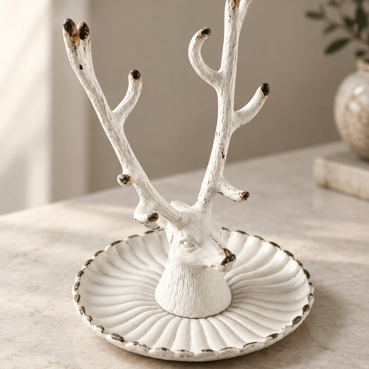 Detail of the stag head and fluted scalloped dish with an antique white distressed finish
