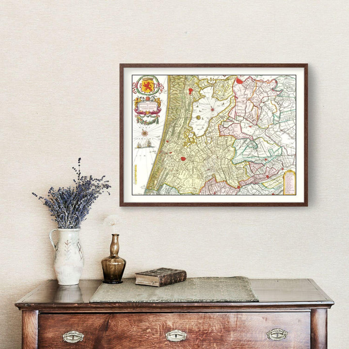 Antique Map of Amsterdam, Netherlands from 1665 framed on a wall above a wooden cabinet with decor.