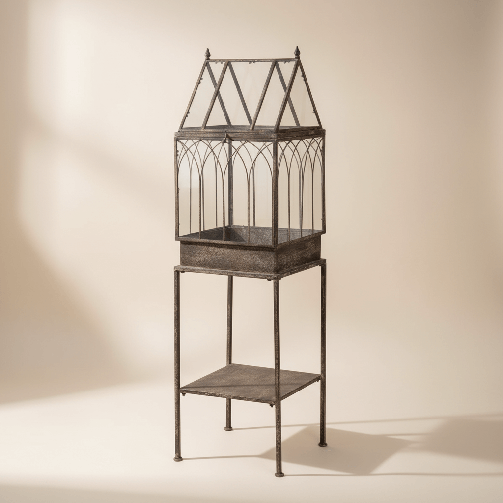 Antique Black Iron Standing Garden Terrarium with Gothic Arch Detail against a beige background