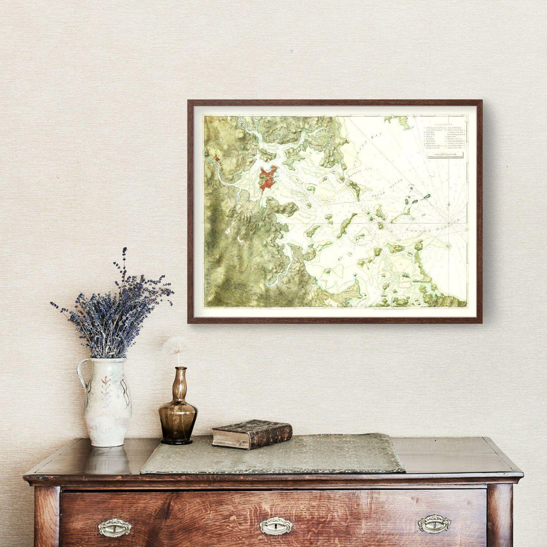 Antique Boston Harbor Map from 1775 framed on wall above vintage console.
