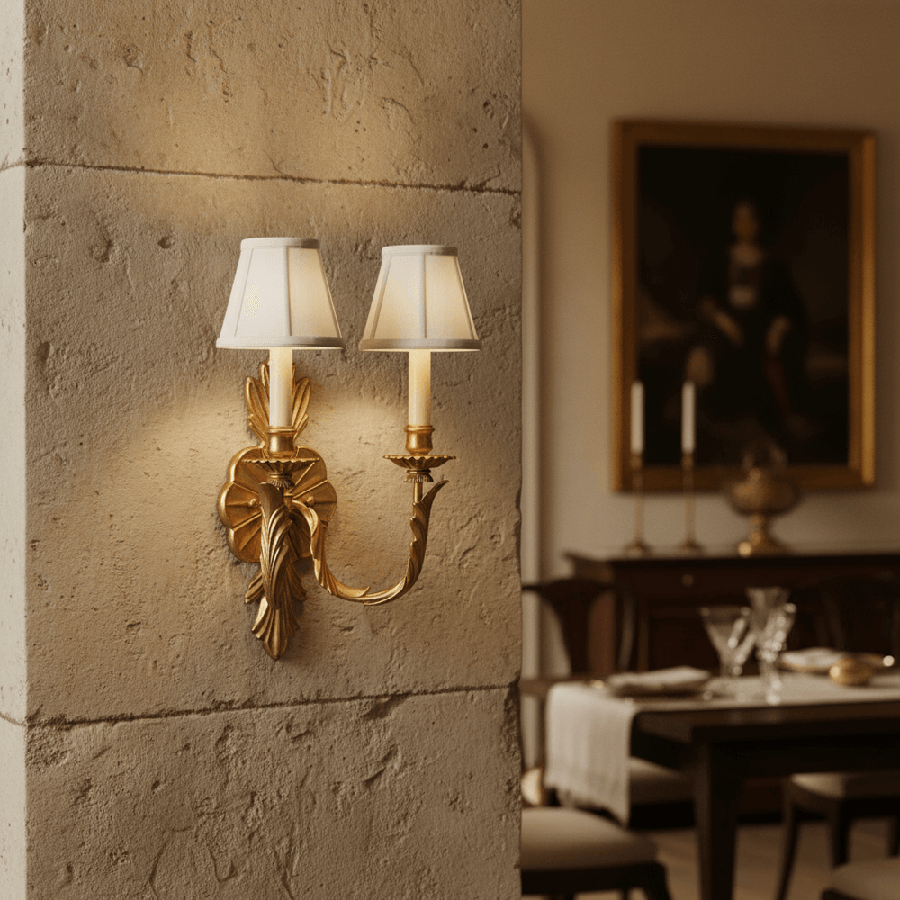 Antique Brass Double Arm Sconce with Pleated Shades in a vintage-style dining room.