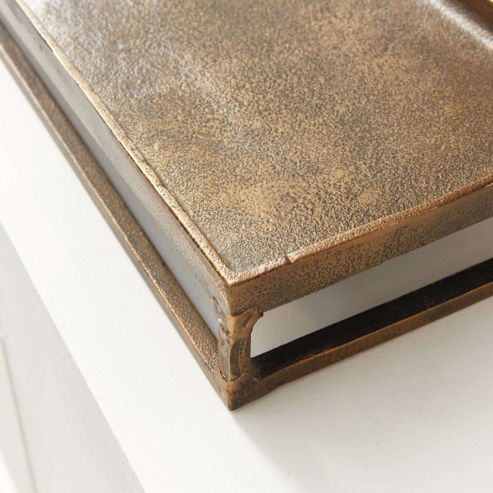 Close-up of antique brass raised display tray, showcasing artisanal craftsmanship with a warm, rustic finish and elevated design.