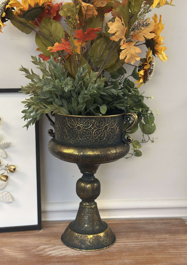 Antique bronze ornate metal urn with floral arrangement, featuring classic design and hand-rubbed gold highlights.