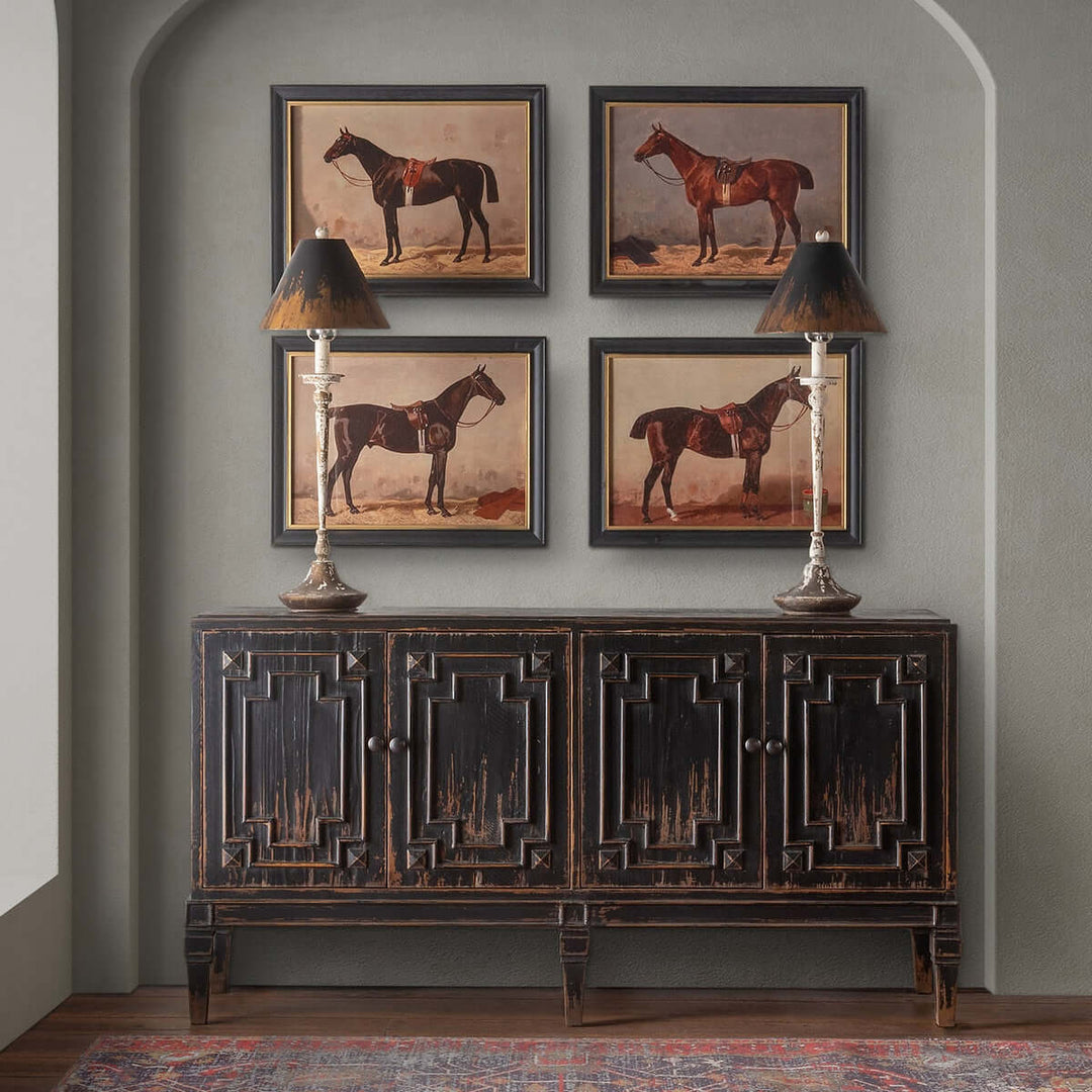Antique farmhouse buffet with distressed lamps and horse paintings on wall, creating an elegant rustic decor ambiance.