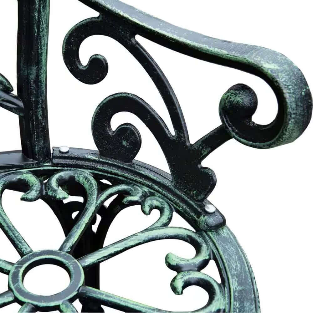 Detail of Antique Green Metal Garden Bench with Rose Backrest, featuring scrolling and floral designs.