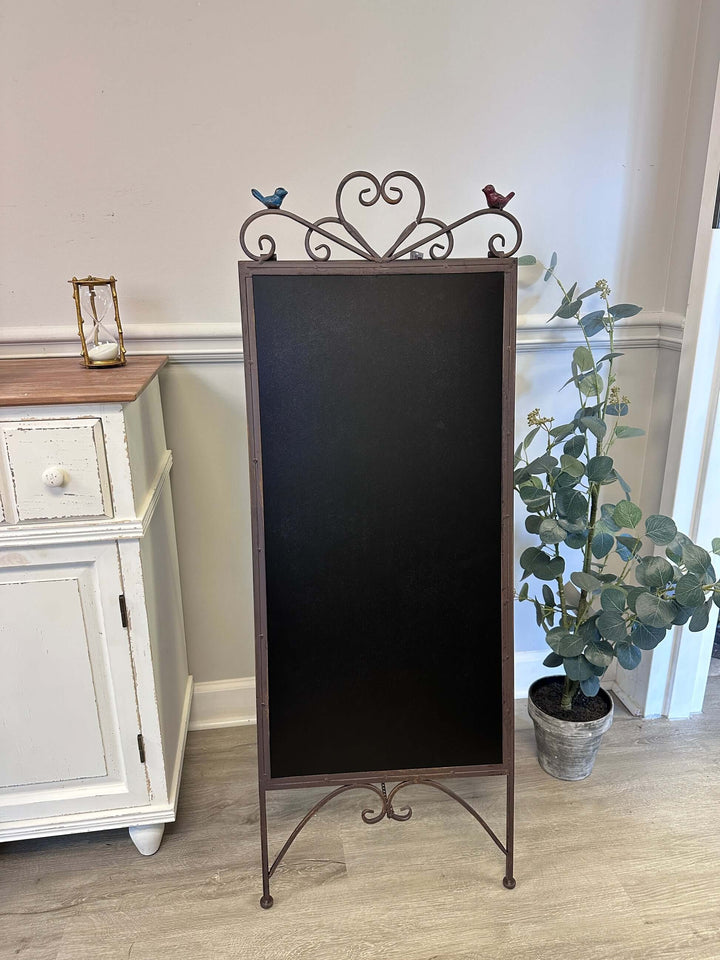 Antique iron chalkboard easel with heart scroll and bird design, perfect for vintage décor and hand-written messages.