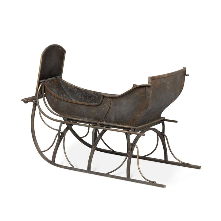 Antique Iron Cutter Sleigh Christmas Décor, vintage metal sleigh, nostalgic holiday decoration, 19th-century style, winter charm