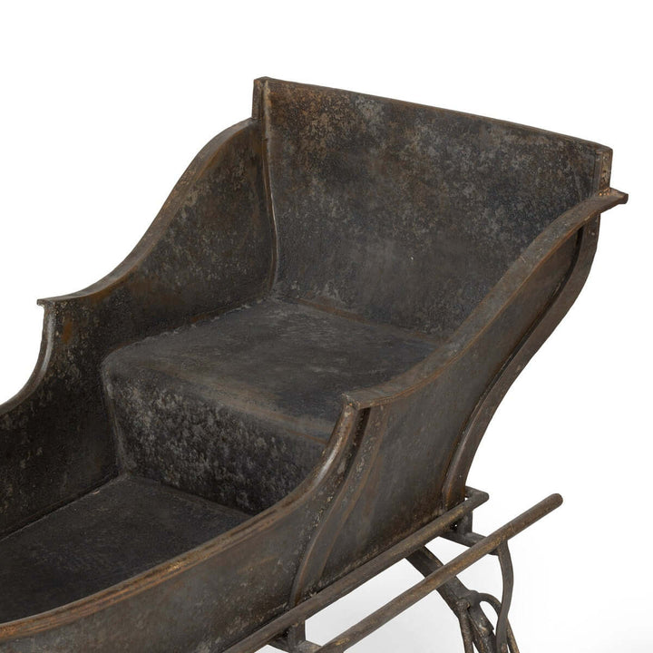 Antique Iron Cutter Sleigh Christmas Décor capturing vintage winter charm with horse-drawn sleigh design and nostalgic appeal.