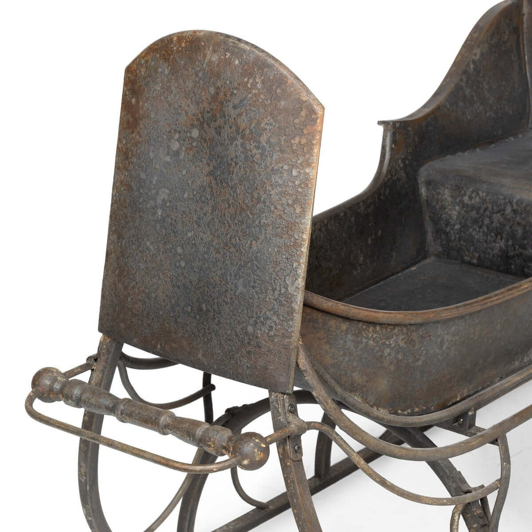 Antique Iron Cutter Sleigh Christmas Décor with rustic metal design, capturing nostalgic winter charm for festive home styling.