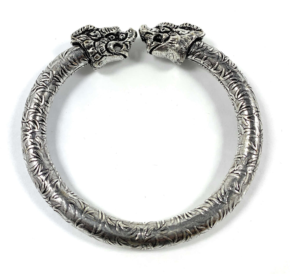 Antique Norse Viking Cuff Bracelet with Lion Heads in silver, showcasing intricate craftsmanship and historical design influence.