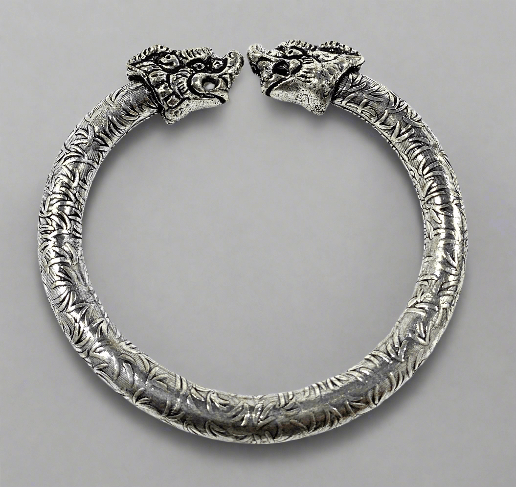 Antique Norse Viking Cuff Bracelet with Lion Heads featuring intricate silver design and lion head details.