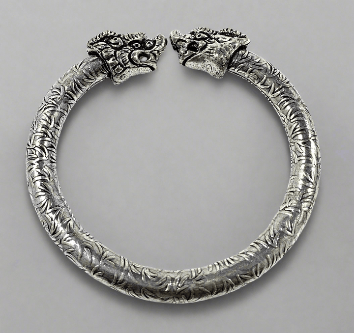 Antique Norse Viking Cuff Bracelet with Lion Heads featuring intricate silver design and lion head details.