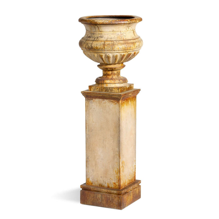 Antique-style iron garden urn with tall pedestal in aged rusted patina.