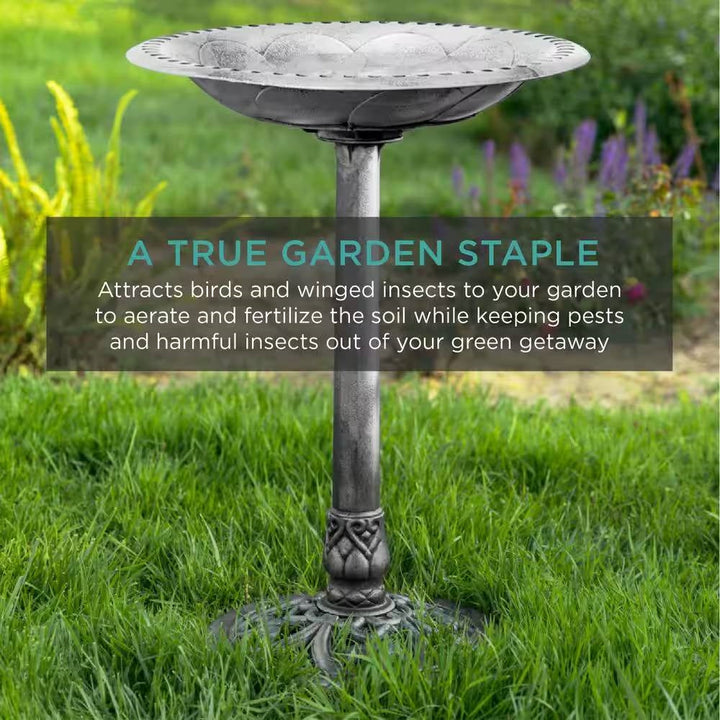 Antique Style Silver Bird Bath in a green garden, highlighting rustic aged silver finish for outdoor decoration and wildlife attraction.