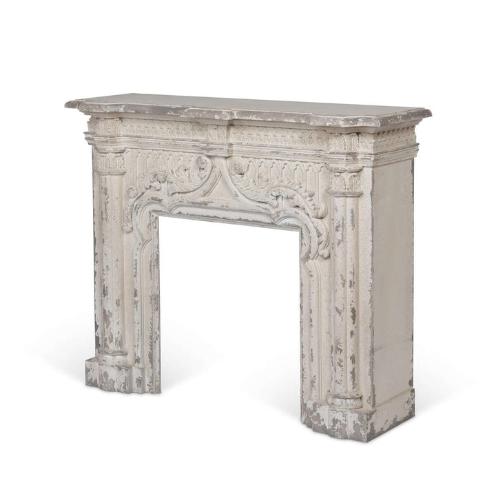 Antique white fireplace mantel with distressed vintage finish, showcasing elegant silhouette and classic charm.