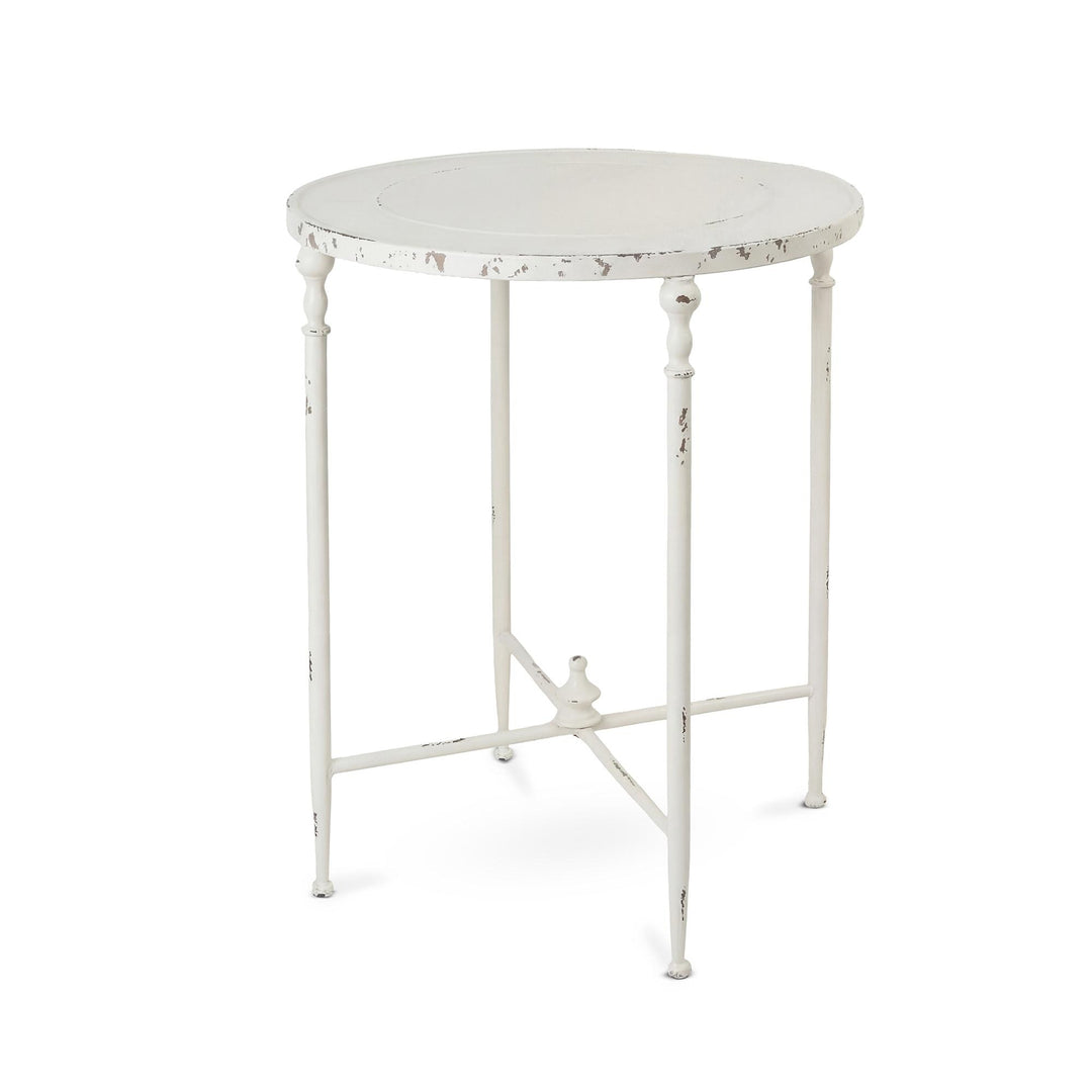 Antiqued white iron round side table with slender decorative legs, a raised tabletop edge and cross-braced base.
