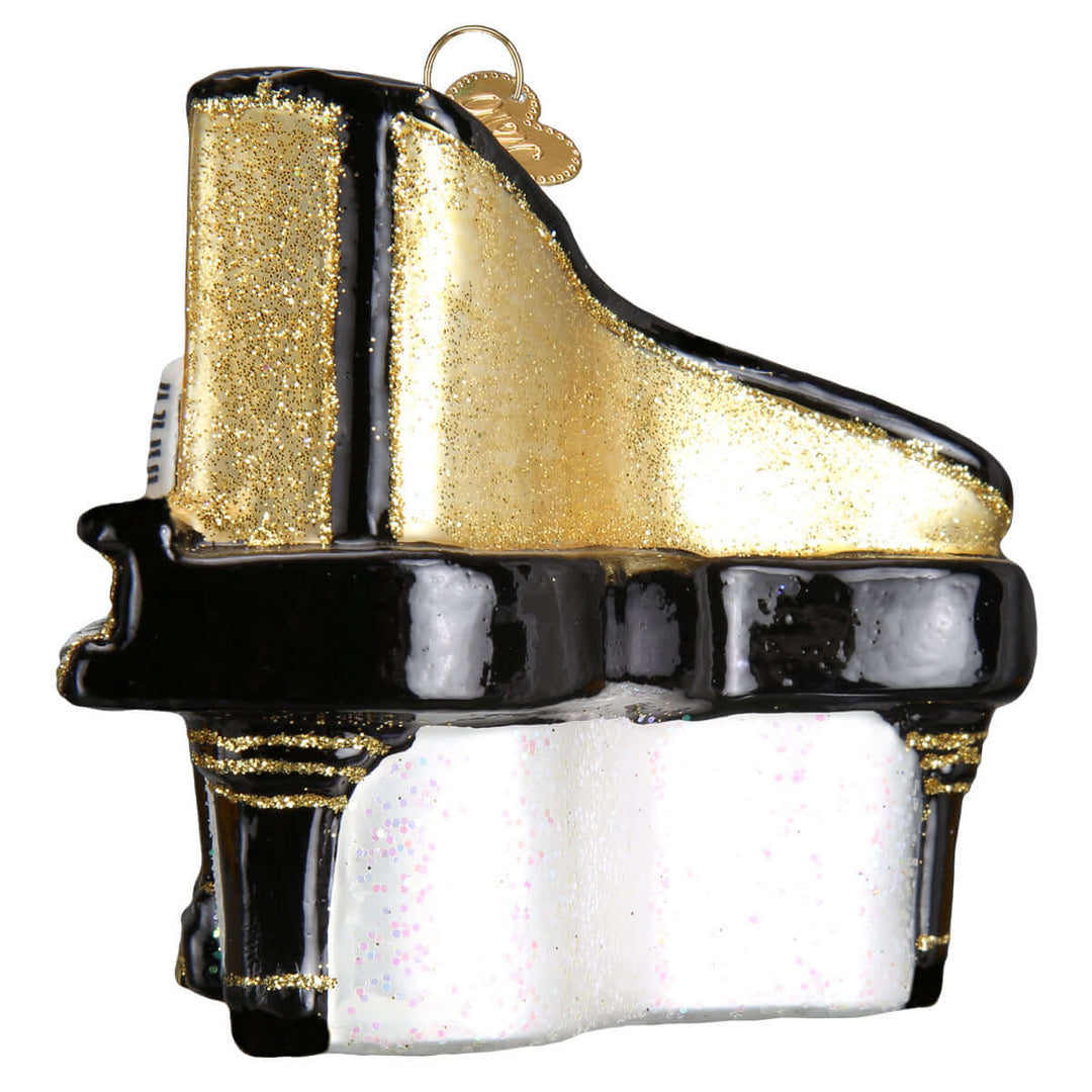 Elegant Baby Grand Piano Christmas Ornament with gold accents on a reflective surface, perfect for festive tree decoration.