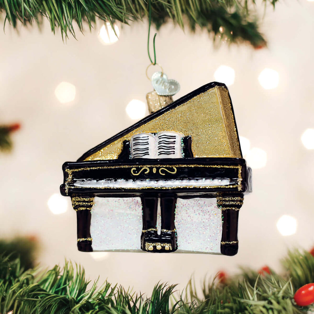Baby Grand Piano Christmas Ornament hanging on a festive tree, showcasing a miniature piano design with elegant details.