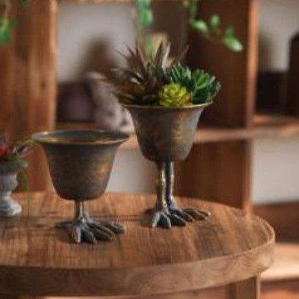 Bird Claw Metal Pedestal Planter in a moody collected interior