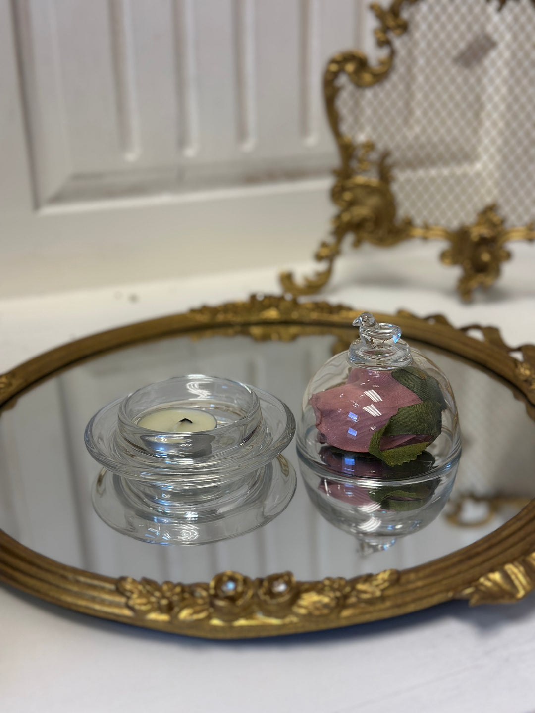 Two Bird-Topped Glass Cloches styled with small keepsakes