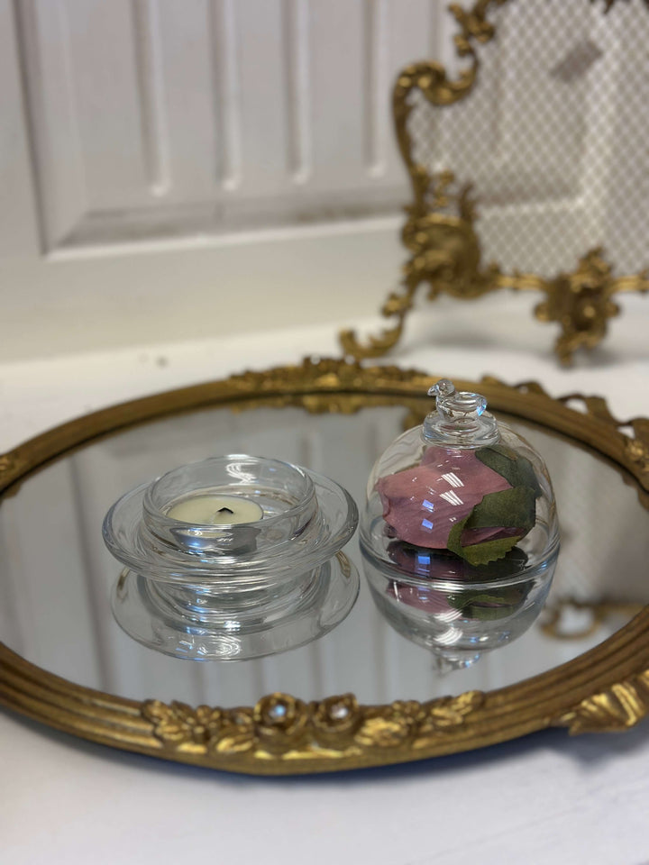 Two Bird-Topped Glass Cloches styled with small keepsakes