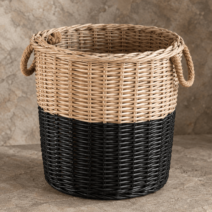 Close detail of a rope handle, braided willow rim, and natural-to-black finish on a storage basket.