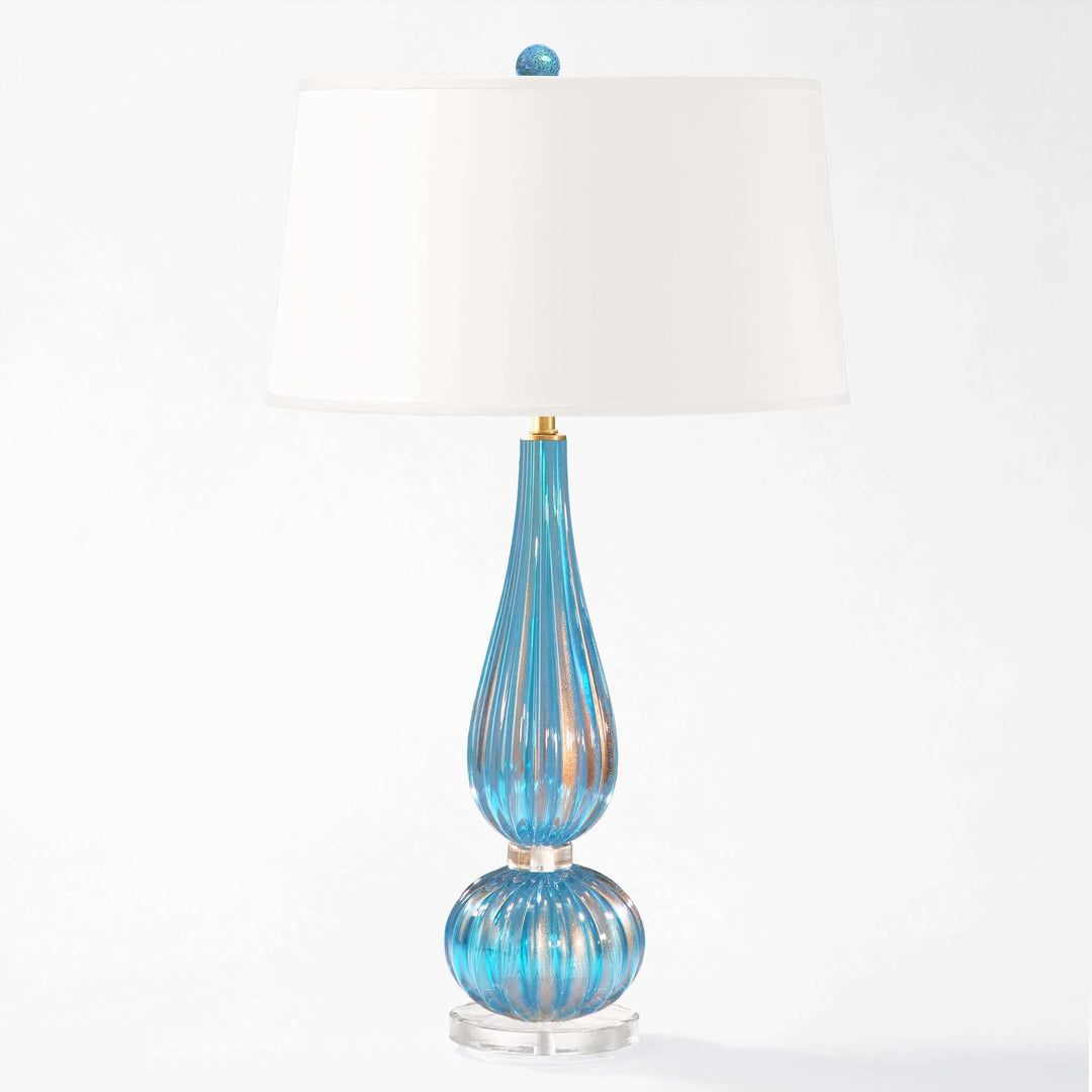 Blue glass table lamp with white shade on a white background