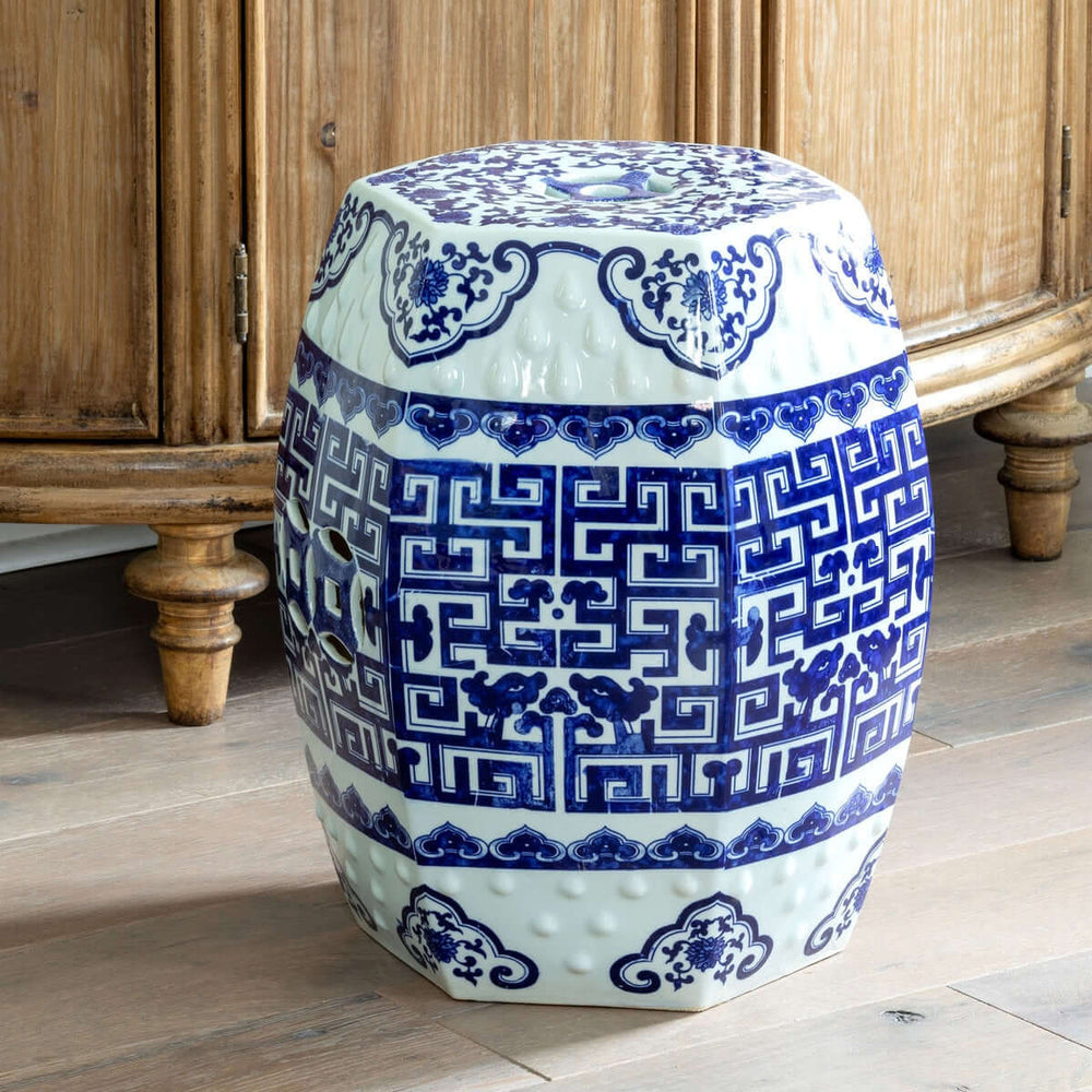 Blue and white Chinoiserie porcelain garden stool with intricate patterns, inspired by traditional Chinese and European designs.