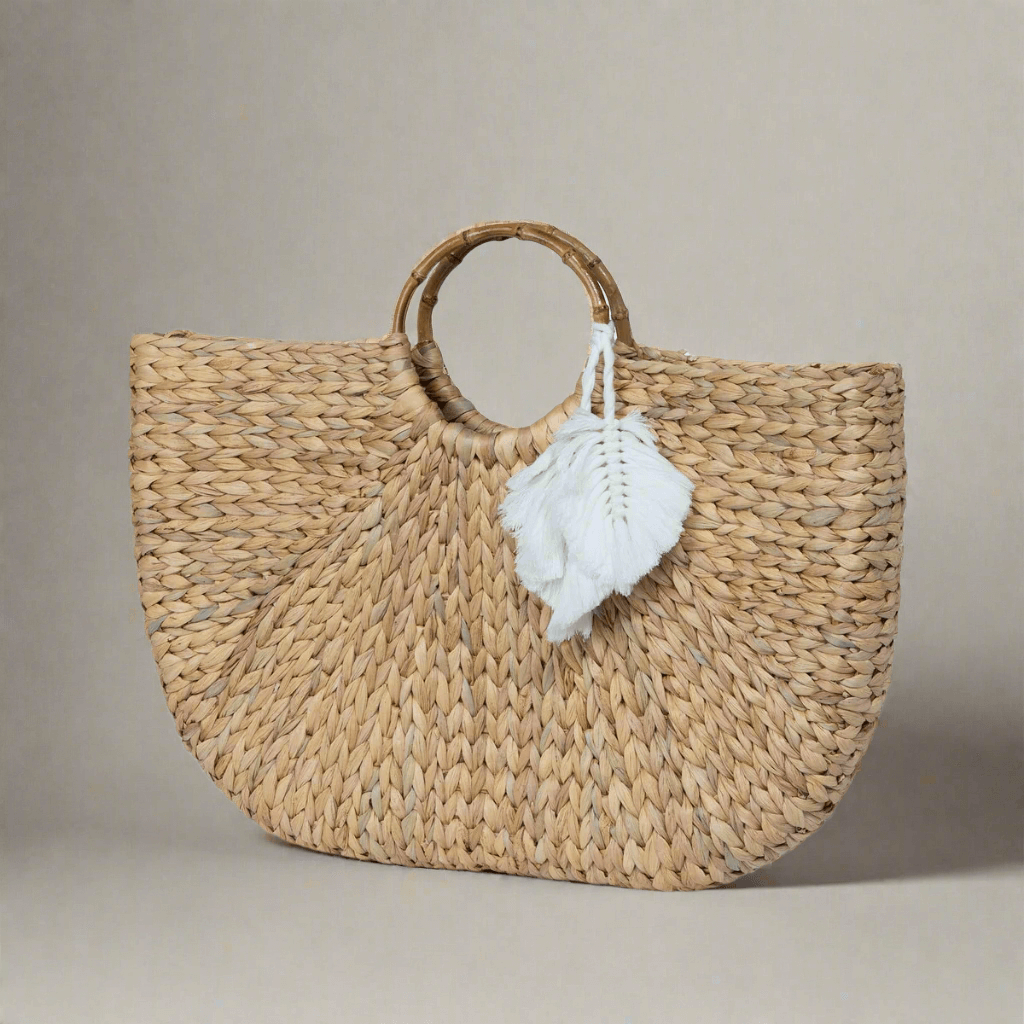 Boho Chic Handwoven Straw Tote Bag with circular handles and white tassel, showcasing artisanal craft and bohemian style.