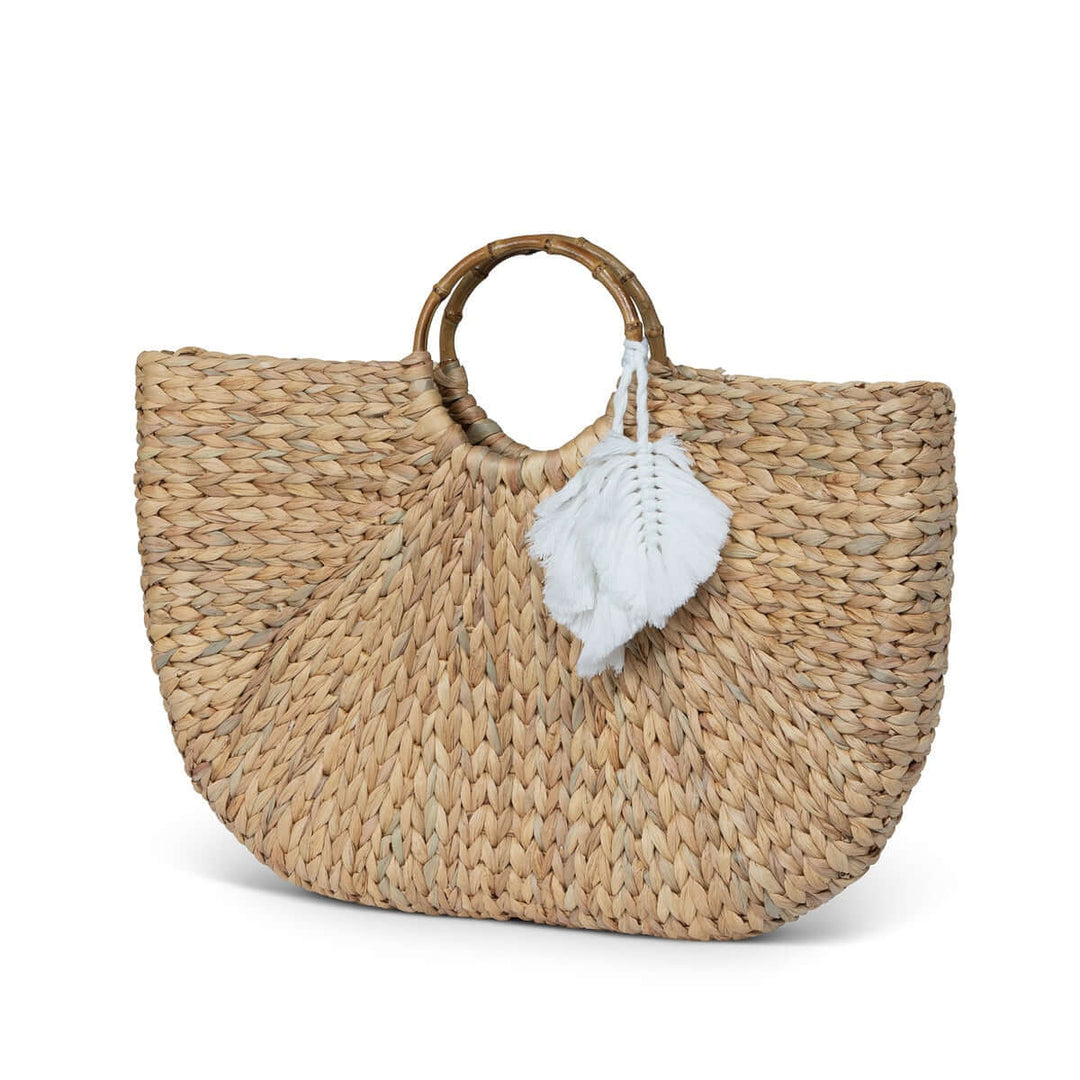 Boho Chic Handwoven Straw Tote Bag with circular handles and white tassel detail, showcasing artisanal craftsmanship and bohemian style.