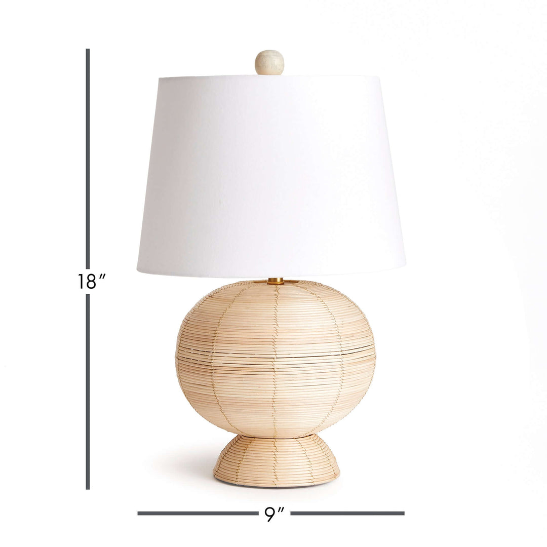 Boho globe rattan lamp with tapered white shade, 18 inches tall and 9 inches wide, illuminating with soft, diffused light.