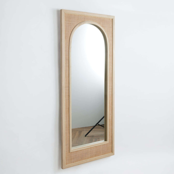 Tall arched boho rattan wall mirror with earthy texture, perfect for bohemian-style home decor.