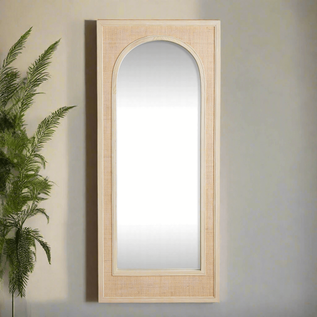 Boho rattan wall mirror in tall arched design, adding elegance and style to any bohemian living space.