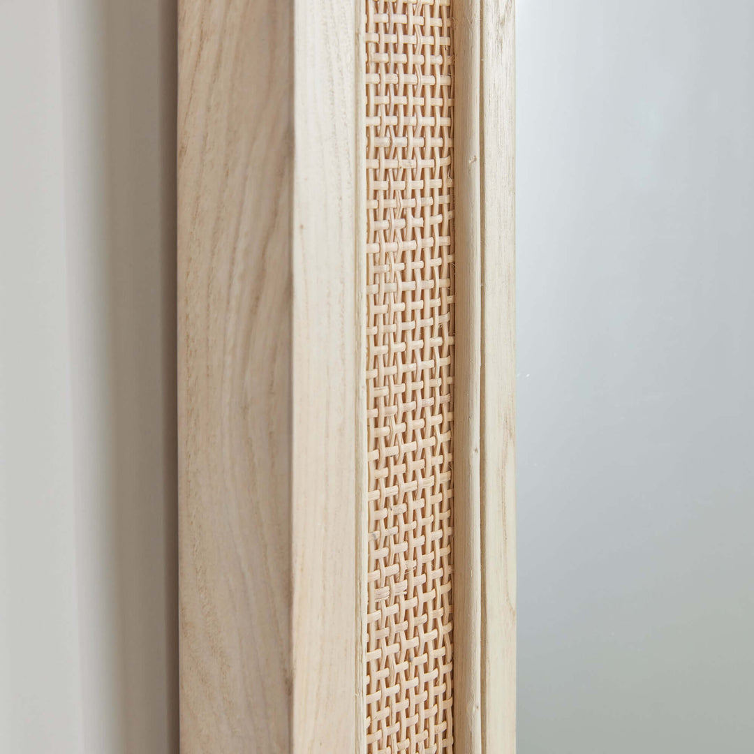 Close-up of the boho rattan wall mirror showcasing its natural wood frame and woven texture.