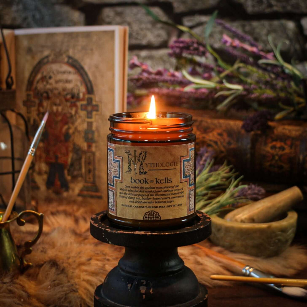 Book of Kells Candle with ancient book and lavender, evoking monastic tranquility through scents of ink, leather, and sweet musk.